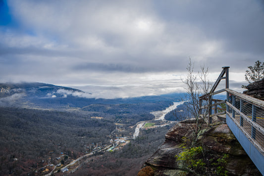 Scenic view from a high vantage point with a river and mountains in the distance.